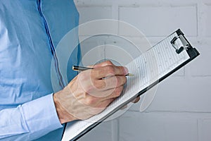 ..Hand of businessman signing document