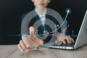 Hand of Businessman  touching showing a growing virtual hologram stock on laptop, planning and strategy, Stock market, Business