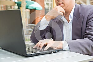 Hand of Businessman typing on Notebook or Laptop Computer