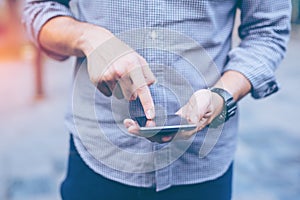 Hand of businessman using while reading his smartphone