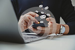 Hand of businessman using smartphone with e-mail icon