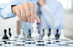 hand of businessmen moving chess in competition shows leadership, followers and business success strategies