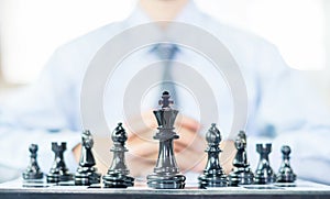 hand of businessmen moving chess in competition shows leadership, followers and business success strategies