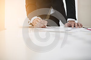 Hand of businessmen write business document charts at office desk. He are analyzing. brainstorming concept..