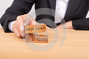 Hand of businesswoman choosing wood blog with icon and word New