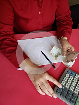 hand of a businesswoman counting peruvian banknotes