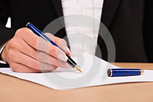 Hand of businesswoman with fountain pen
