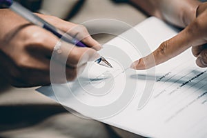 Hand of businesswoman writing on paper