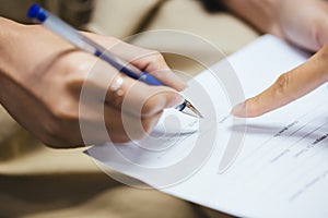 Hand of businesswoman writing on paper photo