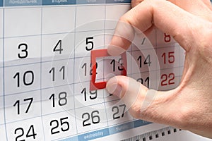 The hand on the calendar moves the pointer from the twelfth to the thirteenth