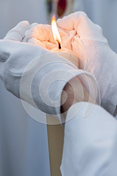 Hand and candle flame