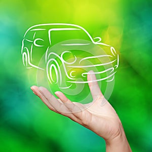 Hand with car against green nature