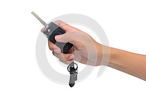 Hand with a car key. Isolated on white background.