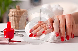 Hand care. Beautiful manicure, woman`s hands with red nails