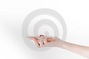 A hand carries smartphone in white background