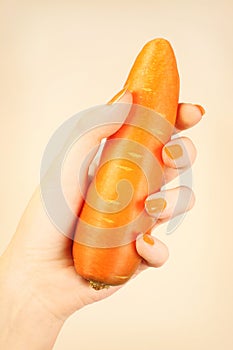 Hand carrot with orange nails manicure