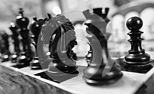 Hand carved, wooden chess pieces seen on a competition wound chess board.