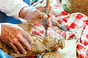 Hand of carver carving wood photo