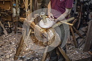 Hand carving a wooden bowl with a foot powered wood lathe,