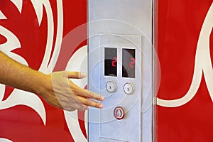 hand of caucasian man pushing the elevator button