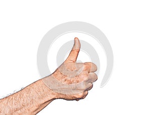 Hand of caucasian middle age man over isolated white background doing successful approval gesture with thumbs up, validation and