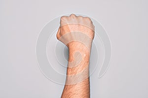 Hand of caucasian young man showing fingers over isolated white background doing protest and revolution gesture, fist expressing