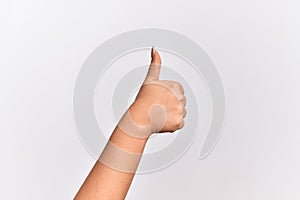 Hand of caucasian young woman doing successful approval gesture with thumbs up, validation and positive symbol