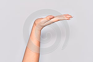 Hand of caucasian young woman with flat palm presenting product, offer and giving gesture, blank copy space