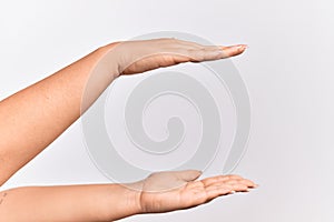 Hand of caucasian young woman holding copy space between them, measuring with both palms