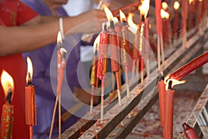 Hand cense joss stick to at an incense burne