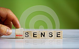 Hand changes the word `Sense` to ` Non sense