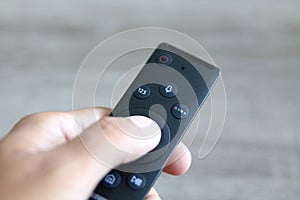 hand changing channels with a remote control