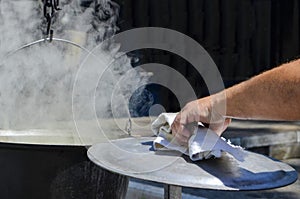 Hand of chef open hot stream pot steam.