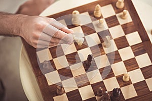 Hand of chess player making a move of check mate during game