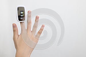 Hand of child girl with fingertip pulse oximeter on finger for examination of the lung disease,checking for Coronavirus COVID-19