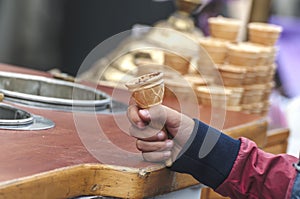 Hand of a child holding a empty cone