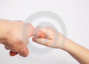 Hand of a child holding parent's finger