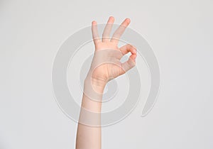 Hand of a child shows a gesture of an agreement/approval