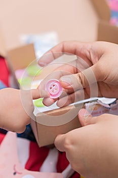 The hand of a child and their mother playing