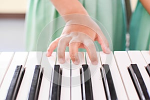 Hand children playing keyboards