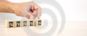 Hand choose franchise or franchising business store icon on cube wooden block stack pyramid for strategy organization company