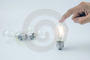 Hand choose a light bulbs with bright light concept for creativity