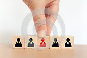 Hand choose wood cube block with red businessman icon for human resources management and recruitment business, build team,
