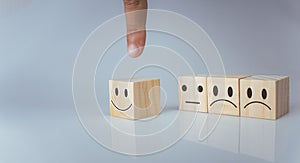 Hand choosing happy smile icon. represents feedback rating and positive customer review, Satisfaction Concept, satisfaction survey