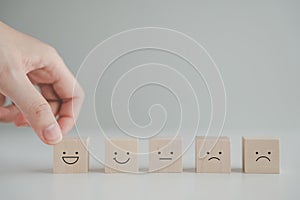 Emotion, World mental health day and Customer experience and satisfaction concept. Hand choosing happy smiling face.