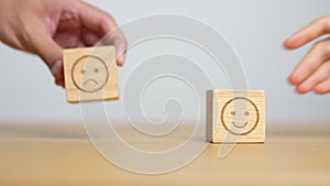 Hand choosing smile face from Emotion block for customer review, good experience, positive feedback, satisfaction, survey,