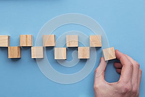 Hand choosing a wooden block from a set. Business choice concept