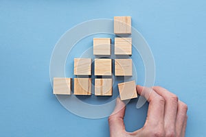 Hand choosing a wooden block from a set. Business choice concept