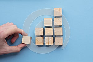 Hand choosing a wooden block from a set. Business choice concept