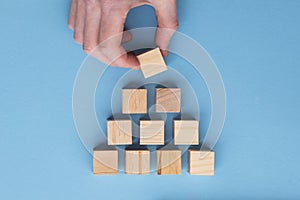 Hand choosing a wooden block from a set. Business choice concept